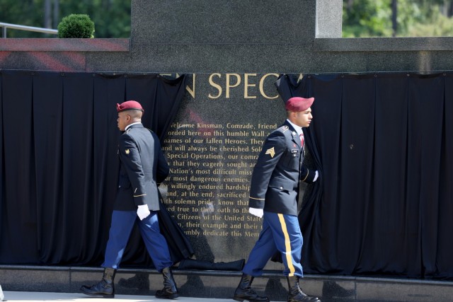 Command Sgt. Maj. Marc Eckard (left), USASOC, command sergeant major and Lt. Gen. Francis M. Beaudette (right), USASOC, commanding general salute following the wreath laying during a USASOC memorial ceremony on May 27, 2021. ...