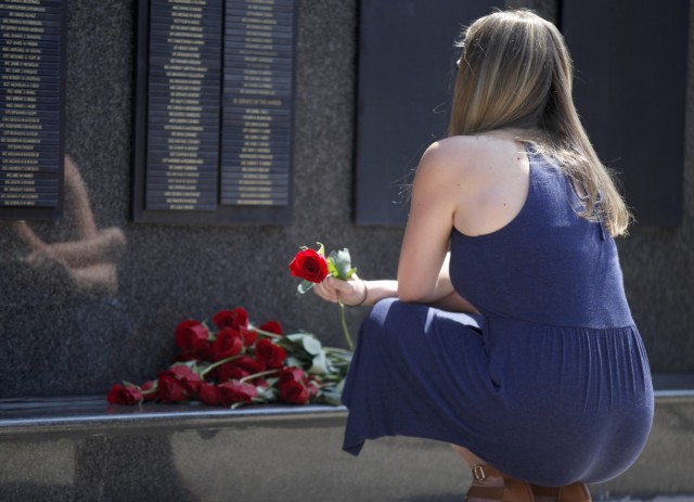 A Gold Star Family Member places a rose on the USASOC Memorial Wall at the conclusion of a memorial ceremony on May 27, 2021. A Gold Star Family member is someone who has lost an immediate family member in the line of duty while serving in the...