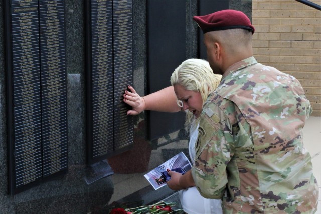 The mother of fallen Soldier Staff Sgt. Ryan C. Knauss kneels by her son’s name plate at the U.S. Army Special Operations Command Memorial Wall on Fort Bragg, N.C. May 25. USASOC invites Gold Star family members each year to the Command’s Gold...