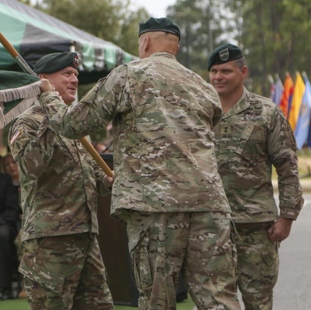 At a November 5, 2019, ceremony, Lt. Gen. Francis Beaudette (left), the Commanding General, U.S. Army Special Operations Command, accepts the 1st Special Forces Command (Airborne) colors from the outgoing commander, Maj. Gen. John Deedrick...